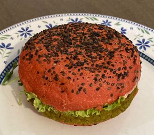 Cherry bomb, with lentil burger, confit tomatoes, salad, soy sprouts, vegan cheddar, rocktail sauce  at Flower Burger in Rome