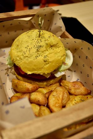 A yellow burger with fries :) at Flower Burger in Rome