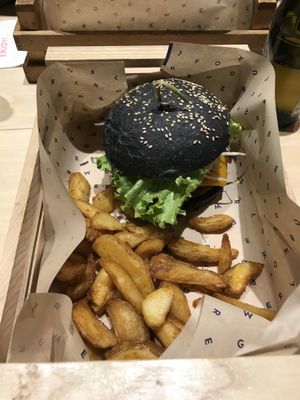 "Flower burger" in a black bread bun. at Flower Burger in Rome