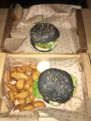 two different burgers. One as a menu with potatoes at Flower Burger in Rome