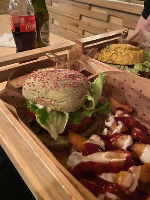 The limited edition Elf burger and Patatas Bravas (wedges with spicy sauce and vegan mayo) at Flower Burger in Rome