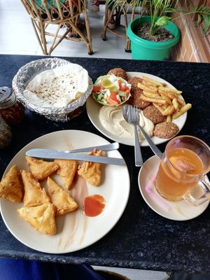 Tofu Pakora (front), Hummus plate with Falafel , Ginger Kombucha at TATTV Cafe in Rishikesh
