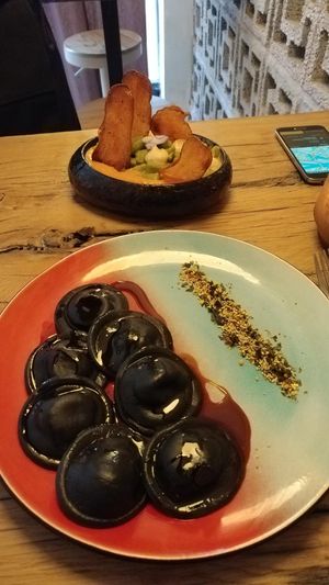 Mains: black shitake ravioli (front) and broccoli Gnocchi with tomato sauce and potato slices (back). at Hearth  in Amsterdam