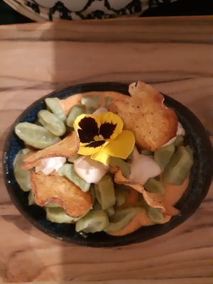 Broccoli gnocchi, zongedroogde tomaten saus, cashew knoflook kaas, aardappel chips at Hearth  in Amsterdam