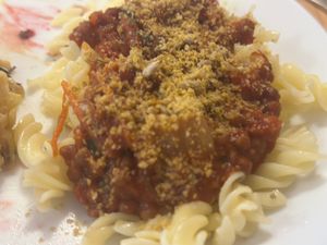 Lentil bolognese with GF pasta and homemade Parmesan .  at Outro Lado in Faro