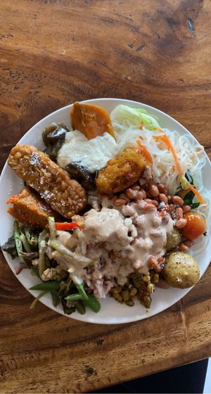 Glass noodles, tempeh, tofu, beans, sweet potatoes, peppers, potatoes, corn fritters with tahini sauce and peanuts.   at Sawobali  in Ubud