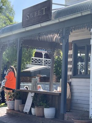 People sitting on the grass out the front of Sweet Meadow  at The Sweet Meadow in Echuca