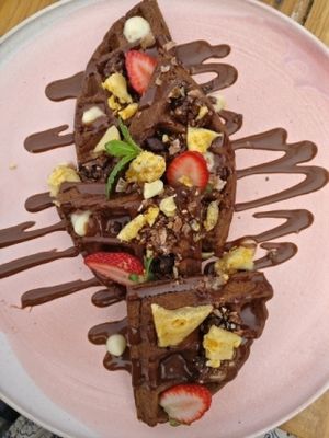 Chocolate waffles, with custard, choc sauce., honeycomb and strawberries at The Sweet Meadow in Echuca
