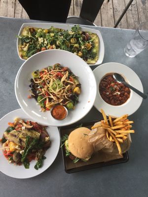 Black bean burger on GF bun with potato fries, grilled veggies, small chilli, taco salad, pizza of the day (pesto sauce)  at V-Eats in Dallas
