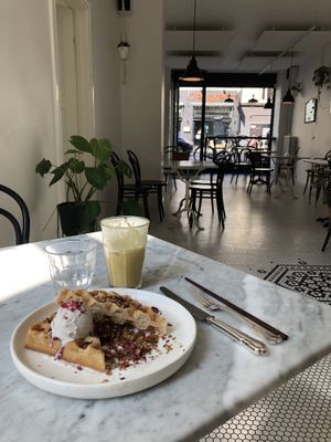 Waffles with coconut ice cream and seasonal fruit. Spicy iced tea to drink.  at Acacia in Frederiksberg