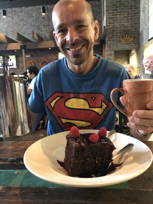Happy 40th - so happy with his huge piece of vegan birthday cake and a really good coffee  at Nacho Daddy - The Strip in Las Vegas