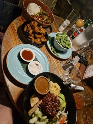 Peanut tofu stir fry on the left, with cauli wings and edamame, I had the Buddha bowl on the right, but it wasn't as good as everything else as it was a lot of raw stuff! at The Banyan Tree in 