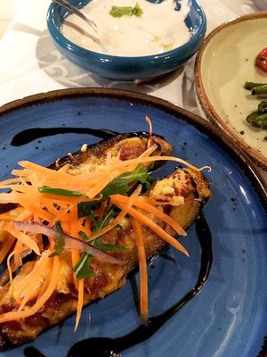 Baked eggplant with vegan cheese and fresh vegetables. Part of vegan meze in Windmill, 2021. at Windmill Restaurant in Paphos