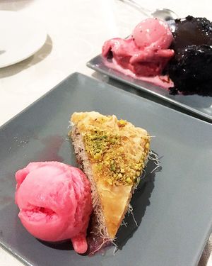 The baklawa with almonds and sugar syrup and rose petals ice cream +
The chocolate cake with raspberry sorbet at Windmill Restaurant in Paphos