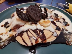 pancake with vegan yoghurt, cholocate sauce and oreos  at KAFETHEA in Maastricht