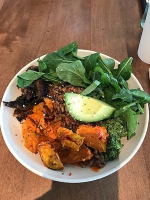 Ancient grains, sweet potato, Portobello mushrooms, avocado, cucumber, pistachio pesto, charred onion, leafy greens, red pepper miso vinaigrette, and hemp seeds.  
Tasty & Filling at Flower Child in Santa Monica