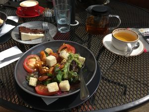 Vegan bowl with peacamole and carrot cake in the background  at Turtle Bean Cafe in Liss