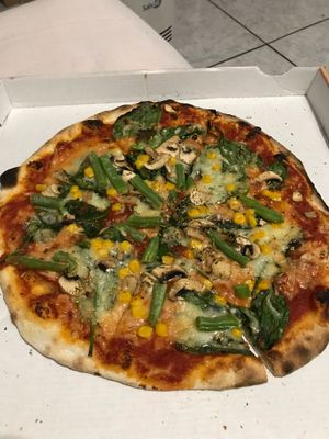 Vegan pizza with spinach, corn, green beans, mushrooms and vegan cheese at Crustys Pizzeria  in Mallorca