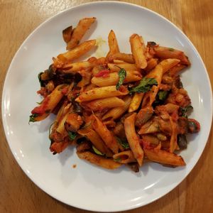 Vegan basil and tomato pasta with eggplants and raisins at VegeQuchnia in Opole