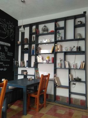 cozy seating area with book exchange at Cafe Del Professor Pitagoras in Merida