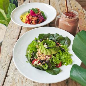 Housemade patty bowl topped with avocado. Sides with organic greens. at Wholey Wonder in Penang
