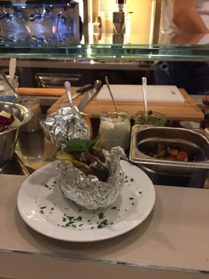 baked potato with tsatziki, antipasti and pickles at Giorgio Lombardi in Berlin
