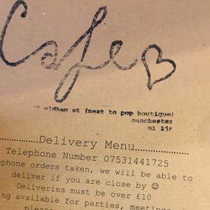 front of menu  at Nibble Cafe in Manchester