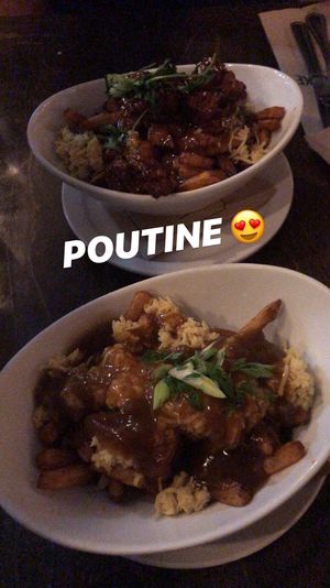 Tao poutine made vegan on top and the vegan poutine on bottom, both delicious ! at L'Gros Luxe in Quebec