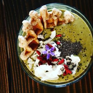 Mystic Matcha smoothie with allergy free waffle, topped with chia seeds, coconut, goji berries and edible flowers.  at The Hunter's Wife Health Bar in Wenatchee
