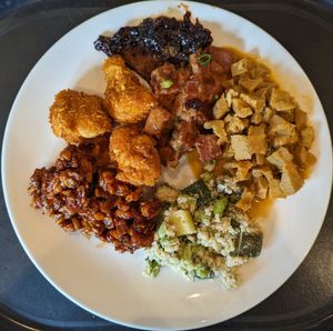 Shiitake Steak, Tempeh in Peanut Sauce, Redang Smoked Seitan, Green Quinoa with Edamame, Tempeh Salad, Corn Fried Cauliflower (clockwise from top) at Spirit in Amsterdam