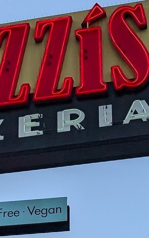 They showcase vegan options on their big sign at Razzi's Pizzeria - Howell St in Seattle