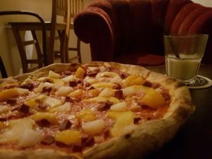 Vegan Antipodi Pizza (vegan cheese, ham, pineapple, mandarin, and peaches) with a vegan White Russian (almond milk, vodka, and kahlua) at Graciarnia in Wroclaw