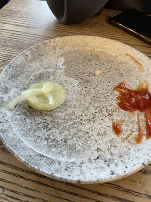 There was so much raw onion, she couldn’t eat it all 😭  at Grindz Cafe in Tauranga