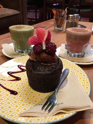 Raspberry muffin + matcha and beetroot latte with coconut milk  at Grindz Cafe in Tauranga