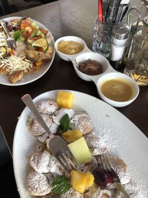 two plates with all hearty and all sweet vegan toppings   at Poffers Cafe in Stuttgart