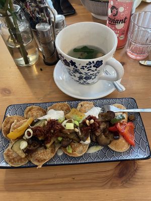 Poffies (small pancakes) with roasted vegetables, vegan cream cheese made from silken tofu, sun tomato crunch, spring onions & roasted pine nuts  at Poffers Cafe in Stuttgart