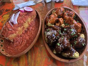 Torta Ahogada (big baguette sandwich with mushrooms covered in salsa) and Alitas Coliflor Capeadas (aka. “cauliflower wings”).  at La Flaca - Americana in Guadalajara