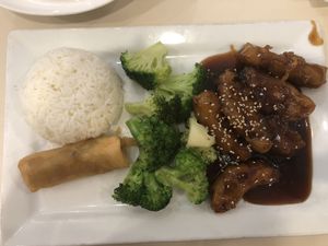 Sesame "chicken" served with white rice, broccoli, and a spring roll.  at VeGreen in Duluth