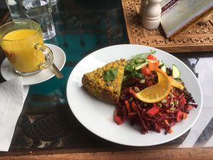 Vegan quiche, superfoods salad, hot coconut milk with tumeric. at Santosa Wellness Centre Cafe in Edinburgh