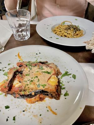 Front: Parmigiana - Aubergine/Eggplant with tomato sauce and coconut based cheese. // Back: Bigoli in Salsa - Vegan version of a traditional Venetian dish !   at La Tecia Vegana in Venice