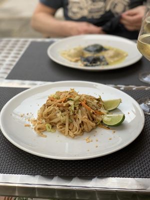 Thai rice noodles with peanut and lime and the handmade black and white ravioli with delicious filling in the back.  at La Tecia Vegana in Venice