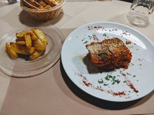 Seitan lasagna, potatoes, and bread in the back. It was carb city for me that night lol at La Tecia Vegana in Venice