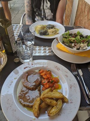 Ravioli, salad with avocado, tofu and cheese and roasted seitan at La Tecia Vegana in Venice