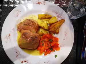 Roast of seitan served with potatoes and carrots at La Tecia Vegana in Venice