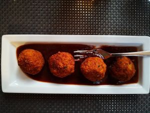 Millet balls with plums and blueberry sauce at La Tecia Vegana in Venice