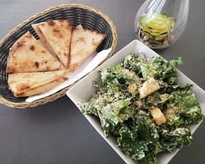 Intro to Falafel dinner plate...Kale Caesar salad and grilled garlicky pita. at The Lemon Tree in St Catharines