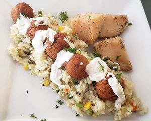 Falafel dinner plate...Lemony roasted potatoes with falafels and tzatziki on a bed of rice and vegetables. at The Lemon Tree in St Catharines