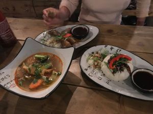 Dumpling soup, fried spring rolls, and steamed bun appetizers at QB Vegan in Berlin