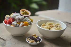 A generous fruit salad, that will keep you full for a long time, and a heart-healthy oat porridge with a homemade crunchy blend of superfoods. at Peace Food Cafe in Sihanoukville