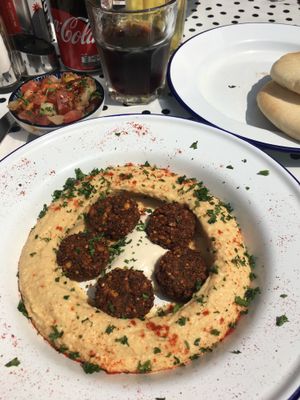 Hummus bowl with falafel and tomato salad  at Chickpea in Antwerpen
